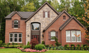 Brick and stone home in wooded area