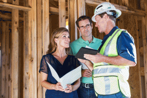homeowners talking to builder in newly constructed home